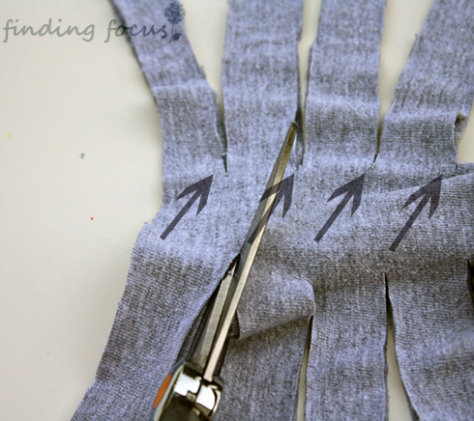 cutting diagonal strips in t-shirt material, creating t-shirt yarn, turning looped t-shirt material into a continuous strip, making a long strand of material from a t-shirt, how to correctly cut t-shirts into strands for yarn